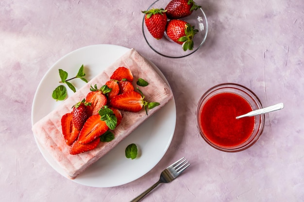 Italian homemade dessert Semifreddo with strawberry sauce cold dessert like an icecream