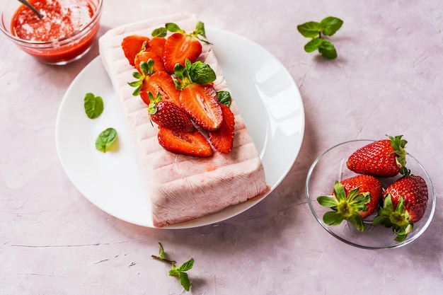 Italian homemade dessert Semifreddo with strawberry sauce cold dessert like an icecream