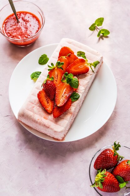 Italian homemade dessert Semifreddo with strawberry sauce cold dessert like an icecream