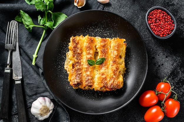 Italian homemade pasta cannelloni with beef and tomato sauce