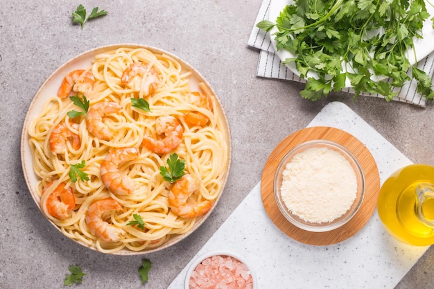 Italian pasta fettuccine or spaghetti in a creamy cheese sauce with shrimp or prawns on a plate