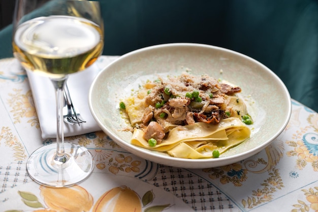 Italian pasta Pappardelle with tomato and mozzarella cheese on table Veggie pasta with tomatoes traditional Italian cuisine