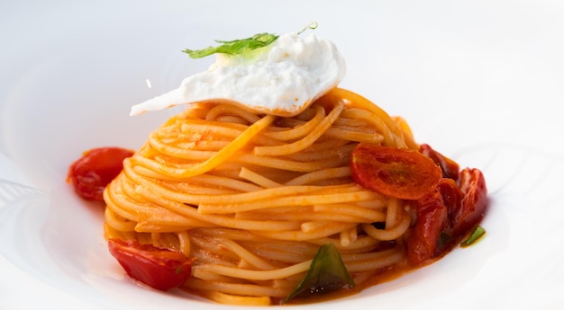 Italian pasta spaghetti with burrata cheese closeup mediterranean diet