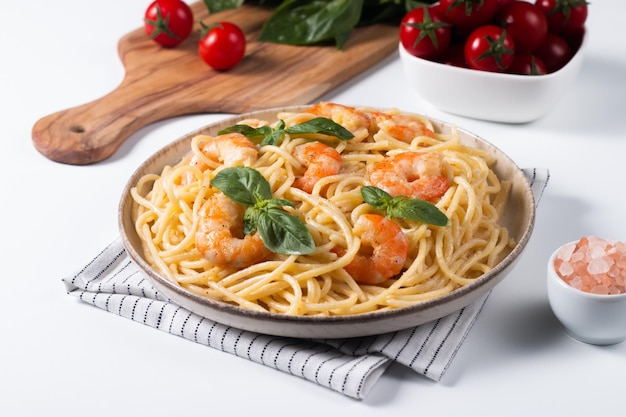 Italian pasta spaghetti with soft cheese sauce with shrimp or prawns on a plate