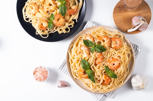 Italian pasta spaghetti with soft cheese sauce with shrimp or prawns on a plate