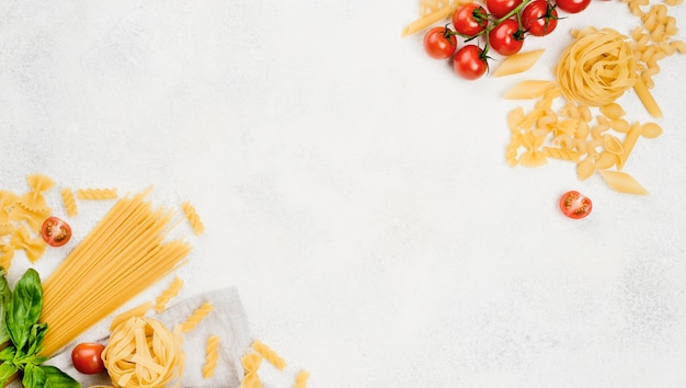 Italian pasta and tomatoes on desk