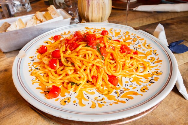 Italian Pasta with cherry tomatoes on big plate