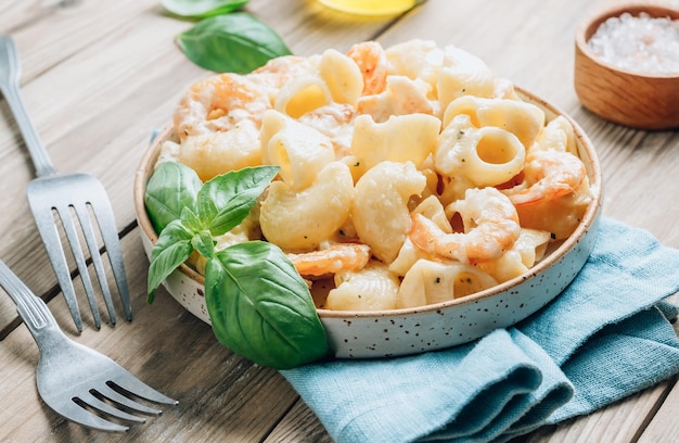 Italian pasta with garlic creamy sauce shrimp and basil