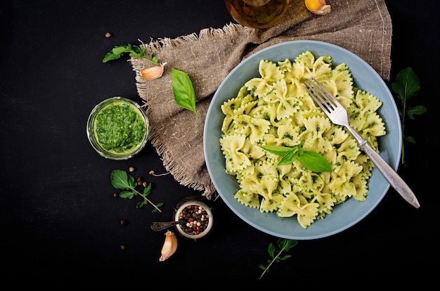 Italian pasta with pesto sauce and basil