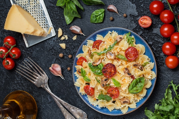 Italian pasta with sauce, cherry tomatoes, basil and parmesan cheese. Delicious pasta plate