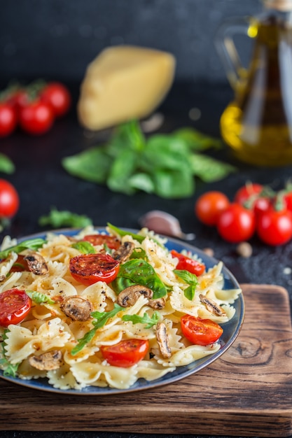 Italian pasta with sauce, cherry tomatoes, basil and parmesan cheese. Delicious pasta plate