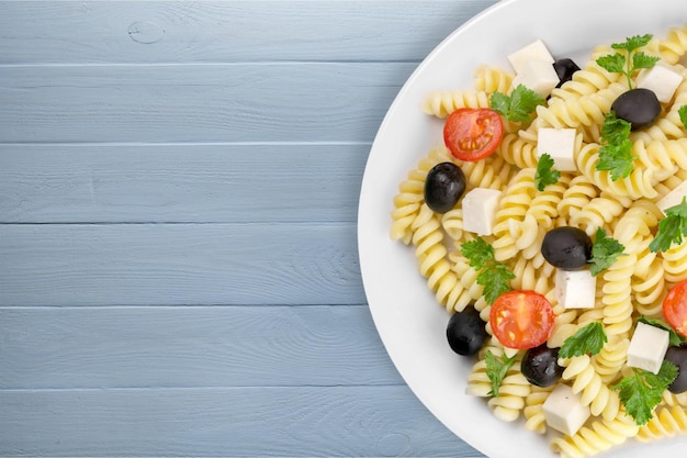 Italian pasta with tomatoes, olives and cheese