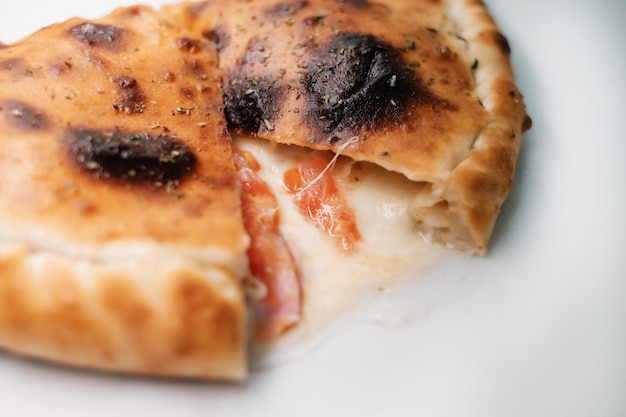 Italian pizza calzone on white table