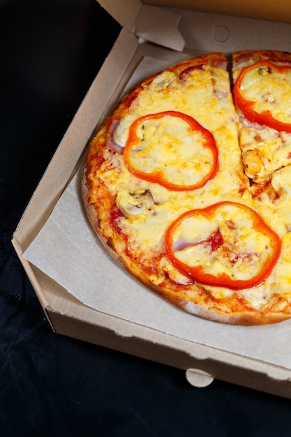 Italian pizza delivery. Delicious oven baked pizzeria dish with, mozzarella, parmesan and cheese, delivered in a cardboard box. Delicious takeaway fast food cooked in the oven for dinner.