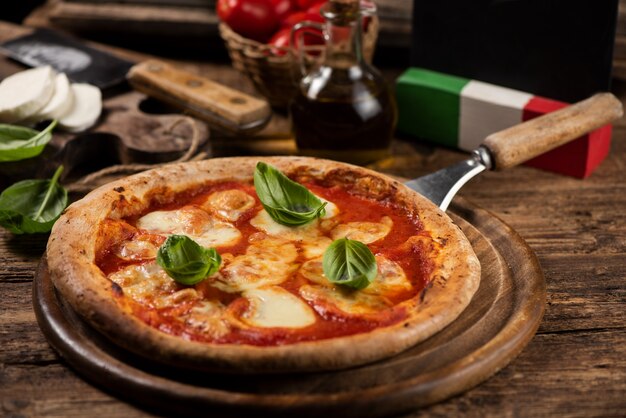 Italian pizza Margherita on a rustic wooden table. Close up