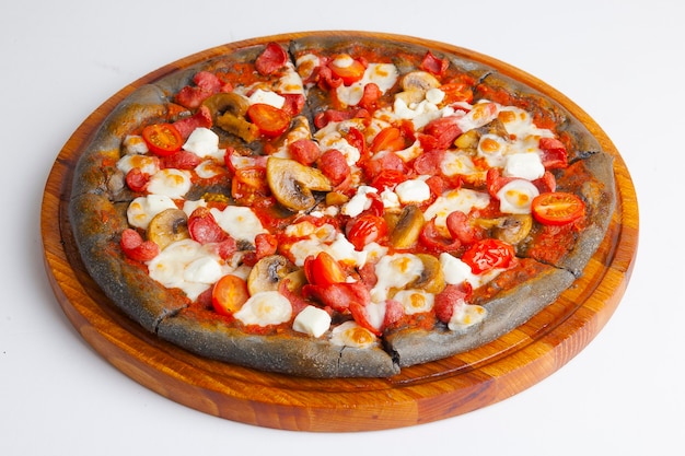 italian pizza with black dough on wooden board