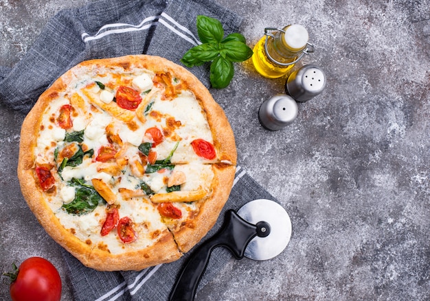 Italian pizza with tomato, mozzarella and chicken