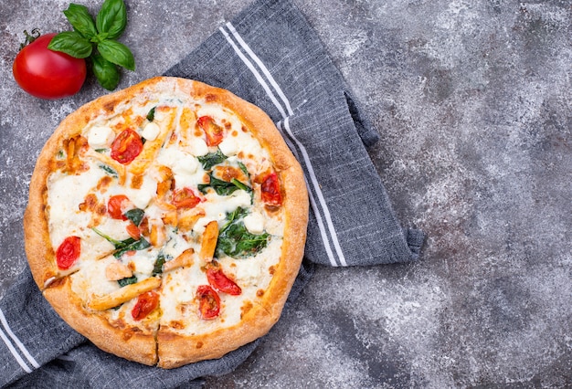 Italian pizza with tomato, mozzarella and chicken