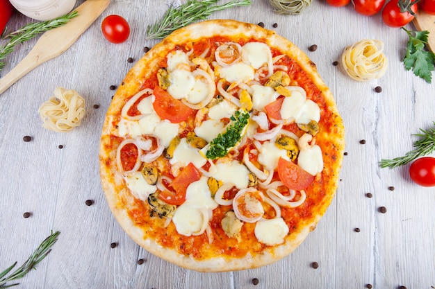 italian pizza on a wooden background with decoration around