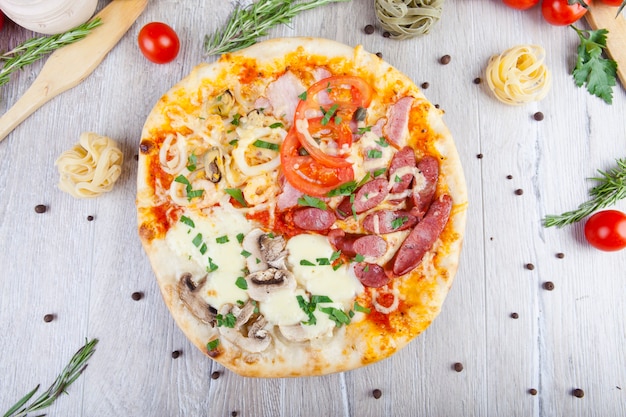 italian pizza on a wooden background with decoration around