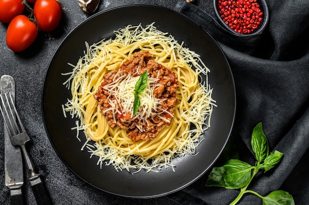 Italian spaghetti pasta with tomato sauce, cheese parmesan and basil