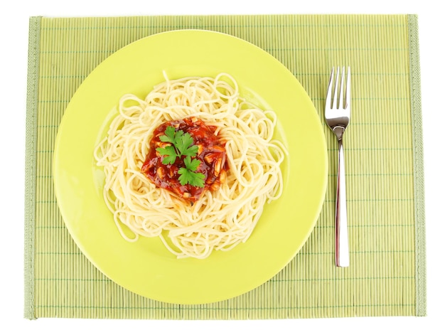 Italian spaghetti in plate on bamboo mat