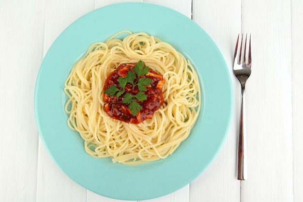 Italian spaghetti in plate on wooden table