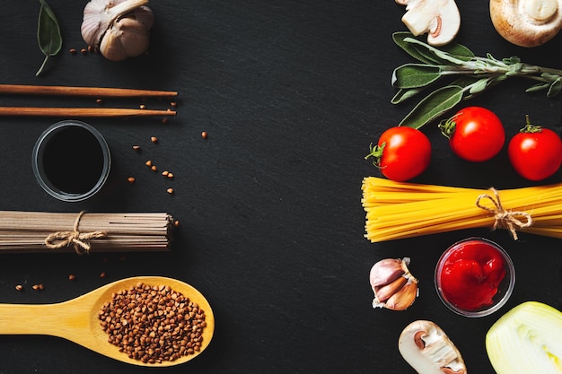 Italian spaghetti vs Japanese soba. Black background, flat lay, copy space. Food background.