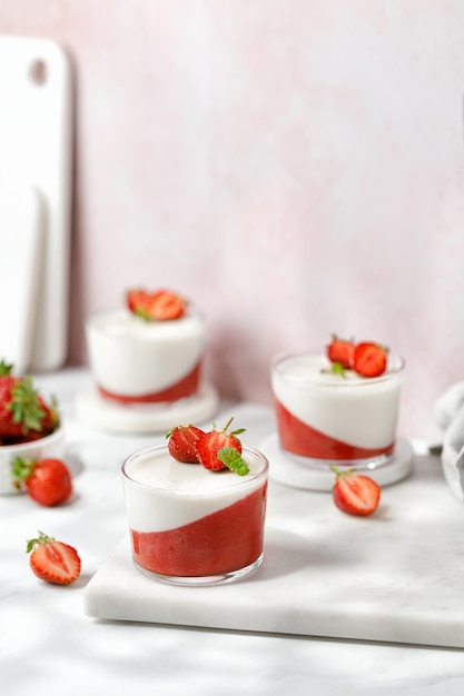 Italian sweet dessert Strawberry creamy dessert panna cotta with strawberry in a glass jars