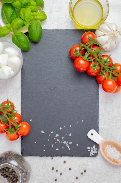 Italian, traditional caprese salad ingredients with cherry tomatoes, mozzarella and basil.