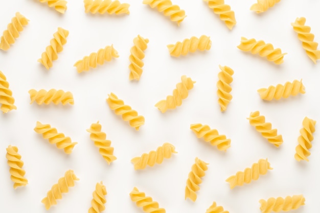 Italian twisted pasta fusilli isolated on white background. Fusilloni, rotini.