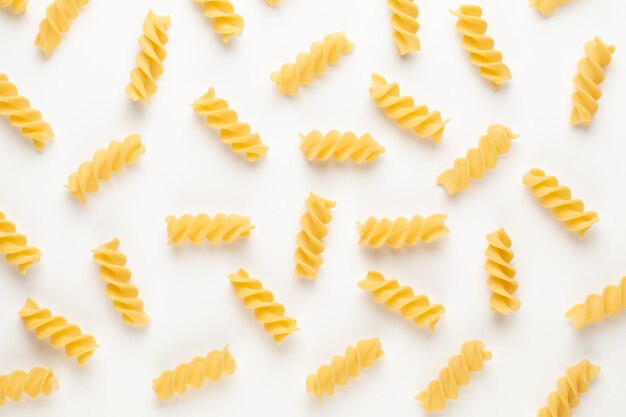 Italian twisted pasta fusilli isolated on white.