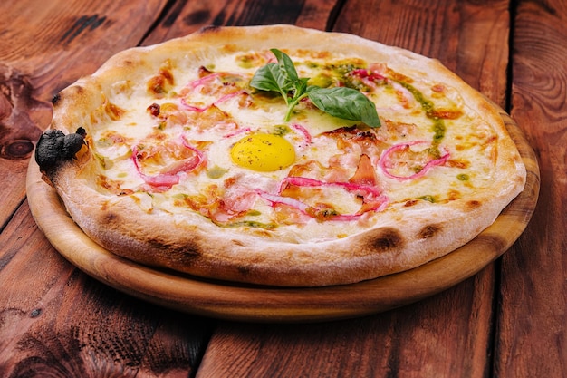 Italy pizza with egg yolk ham and onion