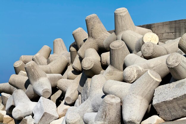 Italy, Sicily, Messina province, concrete tetrapods on the beach near a port under construction