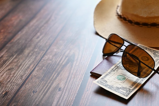 Items for summer vacation a camera passportsmartphone money hat sunglasses Wooden background top view with Copy space Beautiful summer concept for travel and summer vacation