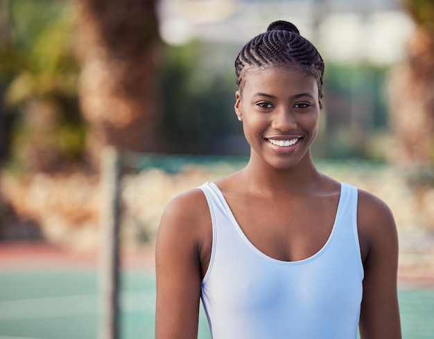 Its about how hard you can get hit. Shot of an attractive young woman standing alone on a tennis court.