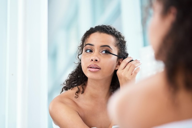 Its not a good day until mascara gets applied Shot of a beautiful young woman applying mascara in her bathroom mirror