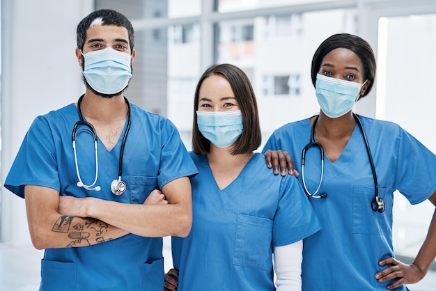 Its our aim to get you to optimum health Portrait of a group of medical practitioners wearing face masks in a hospital