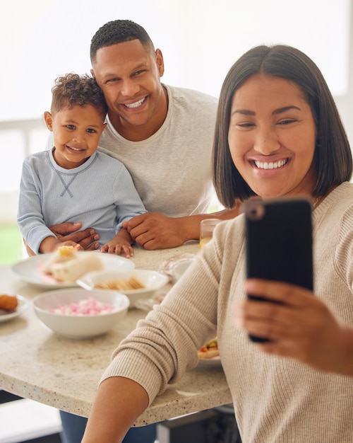 Its not Sunday lunch until weve taken a selfie Shot of a young woman taking selfies during lunch with her family outdoors