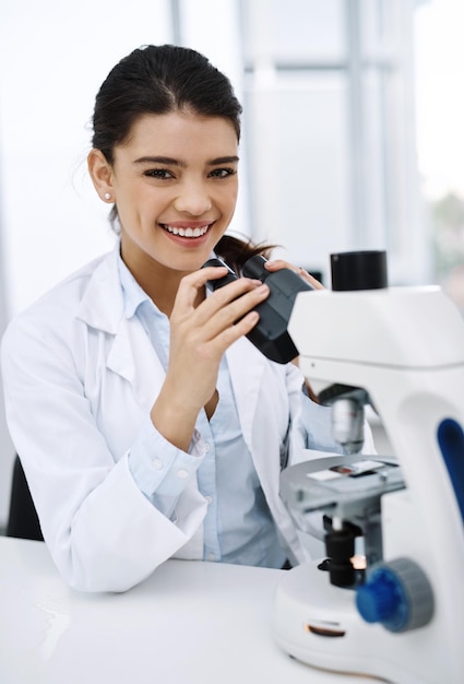 Ive always been curious about the world Shot of a young scientist using a microscope in a lab