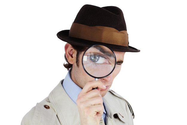 Ive got my eye on you Curious private investigator looking through a magnifying glass against a white background