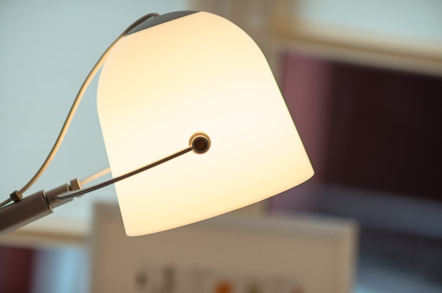 An ivory modern lamp in the interior blurred background