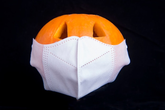 Jack-o-Lantern in the face mask with a black background