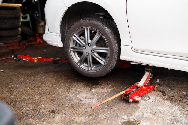 Jacking up a car for change the wheel.