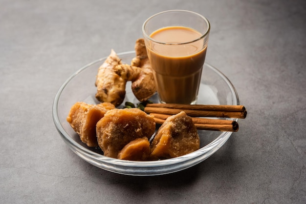 Jaggery tea or Gur ki chai with ingredients like gud ginger or adrak green cardamom and cinnamon