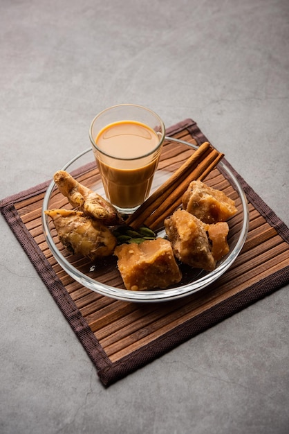 Jaggery tea or Gur ki chai with ingredients like gud ginger or adrak green cardamom and cinnamon