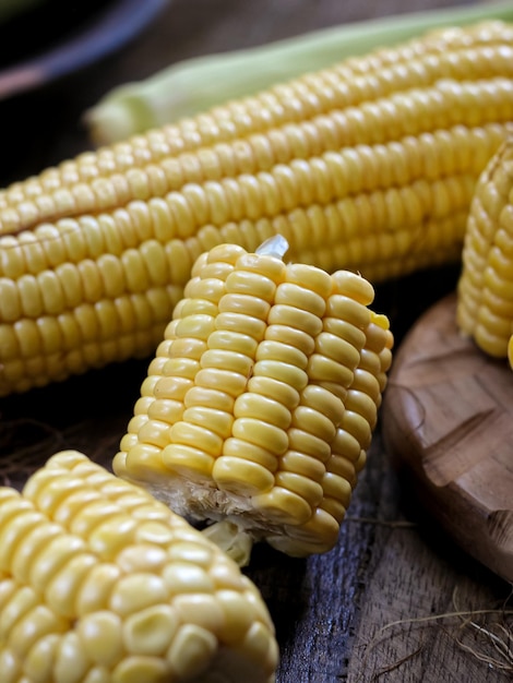 Jagung Manis Segar or fresh sweet corn on cobs on rustic wooden table