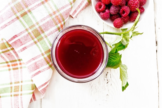 Jam of raspberry in jar on board top