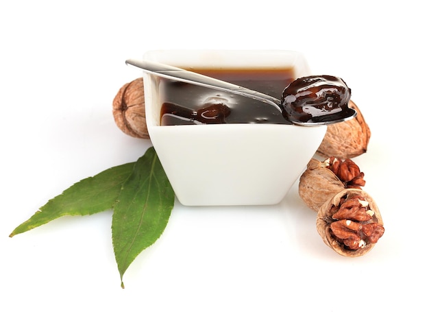 Jam walnuts in a bowl isolated on white