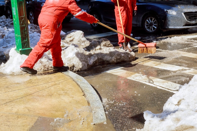 Janitor cleans the street of snow in the morning